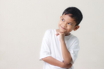 Thinking a cute little asian boy on white background. Child thinking. Education concept. Brainstorming and idea concept.