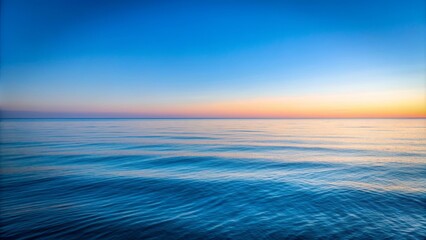 Fototapeta premium Minimalist view of the peaceful blue Pacific Ocean with clear sky at dawn, conveying peace and tranquility