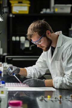 A researcher performs an electrophoresis test, carefully loading samples into the gel and analyzing results The setting, Generative AI