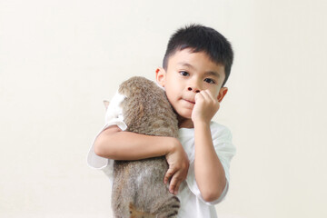 Relationship cat and human. Friendship with pet. Kid hug with gray cat on white background. Emotional support animal.