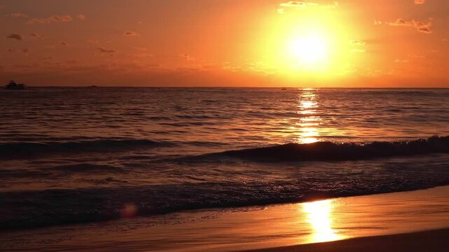 A jet ski and a boat at sunset