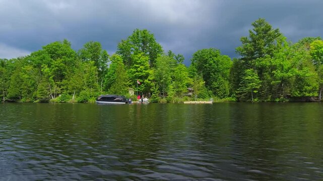 Beautiful evergreen fir trees and rocky coastline view in the lake during trolling fishing in the boat. Hobbies lifestyle fishing. Recreation fishing game sport. Amazing North American nature.