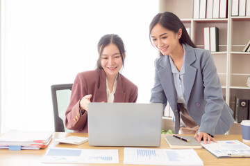 Two Asian accountants brainstorming on financial charts
Financial advisors or analysts discuss financial reports together.