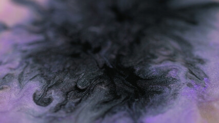 Ink spill. Glitter background. Defocused black purple liquid flow magical shimmering particles...