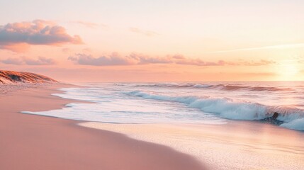 Fototapeta premium Sunset over a tranquil beach with gentle waves lapping at the shore, soft pink and orange hues in the sky, peaceful coastal landscape