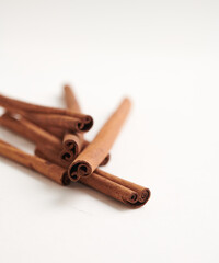a stack of cinnamon sticks isolated on white background. Selective focus