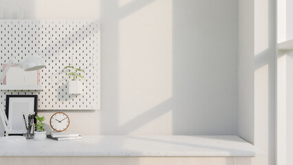 A copy space for displaying products on a white table by the window featuring accessories.