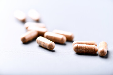 Carnitine capsules. Concept for a healthy dietary supplementation. Bright paper background. Soft focus. Close up.