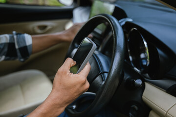 Naklejka premium Asian man feels hurt his neck and shoulders during his long driving in car. Concept Injury, pain or tired from driving. Unsafe driving during abnormal