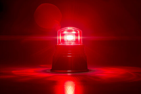 Flashing red siren light isolated on isolated background.