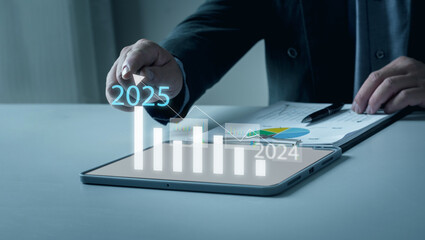 Navigating 2025 Business Landscape. With an eye on the future, a businessman crafts strategic plans to guide his company toward substantial growth and achievement in the year 2025