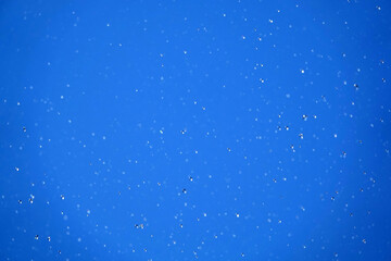 Water in flight on a blue background