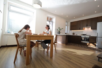 Mother and daughter eating at home