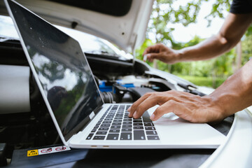 A technician in a workshop uses a wireless device to check a car's condition, updating a digital certificate. The scene highlights automotive repair, service, and efficiency in maintenance.