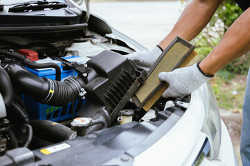 A technician in a workshop uses a wireless device to check a car's condition, updating a digital certificate. The scene highlights automotive repair, service, and efficiency in maintenance.