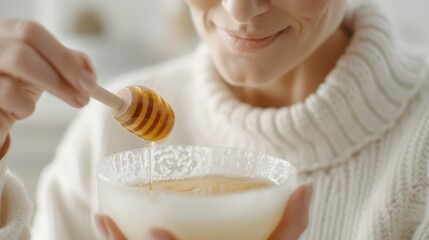 Woman doing DIY honey mask in cozy kitchen, promoting natural hydration and comfort.