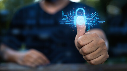 A man raises his thumb to scan a security system.