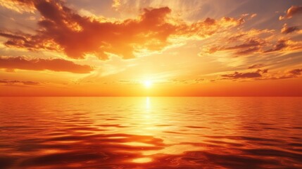 Fototapeta premium Sunset Over a Calm Sea with Golden Clouds