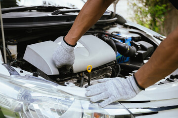 A mechanic inspects a car in a workshop, clipboard in hand, ensuring safety and proper maintenance. The scene captures automotive repair, customer service, and technical expertise.