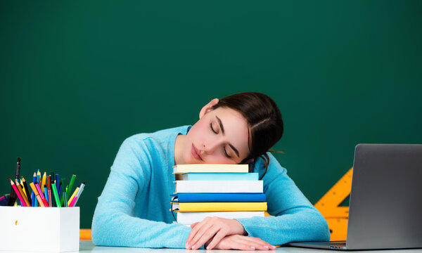 Student sleeping during a lecture in a classroom. Portrait of tired school girl lying and sleeping at desk during lesson. Tired bored Lesson and homework in university.