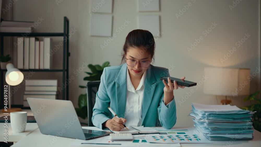 Aufkleber accountant is working late in her office, using the speakerphone function on her phone while taking 