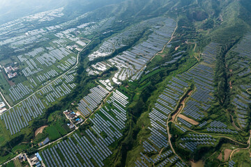 Fototapeta premium view of solar power station on green hill