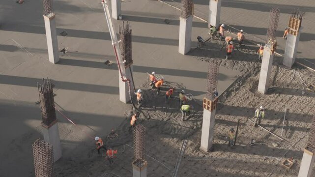 Construction Workers pouring Concrete