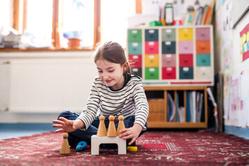 Portrait of schoolgirl using educational tool, learning while playing. Student girl in classroom at...