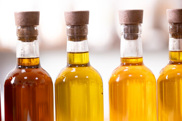 Set craft bottle with oil sunflower, cannabis, black cumin, flax, cedar, castor, camelina, pumpkin seeds on blur background