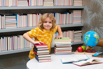 Knowledge day. Child at school. Schoolboy reading book in library. Kids development. Pupil learn to read. Child from elementary school read books in a book store.