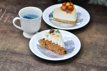 carrot cake with cream and walnut topping ,caramel macadamia cheesecake and butterfly pea tea