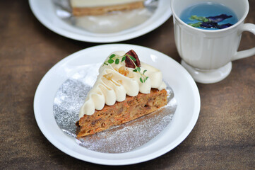 carrot cake with cream and walnut topping , carrot cake and butterfly pea tea