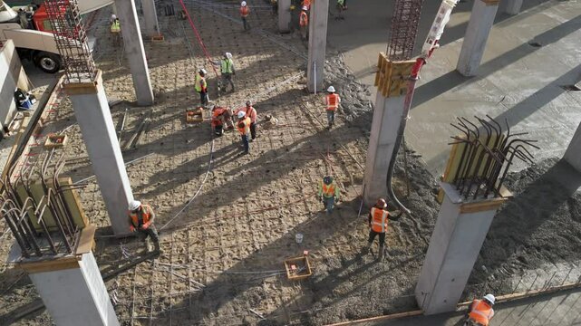 Construction Workers pouring Concrete