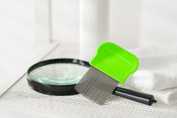 Green Comb on a Countertop with Lice Treatment Products