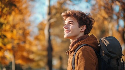 Obraz premium Smiling man walks in autumn nature.