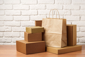 Stacked Cardboard Boxes Against A White Brick Wall