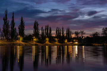 Reflections of Nightfall Lights on the Riverside