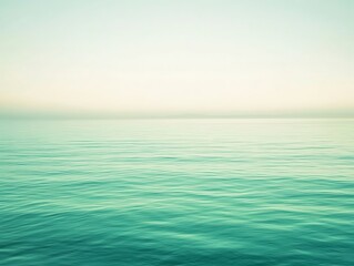 Fototapeta premium Serene sea view with calm, teal water and a soft, pastel sky, creating a tranquil and peaceful atmosphere perfect for relaxation and meditation.