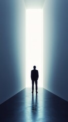 Silhouetted Man Facing Bright Rectangular Light at End of Hallway