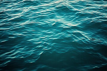Obraz premium Blue green surface of the ocean in Catalina Island California with gentle ripples on the surface and light refracting , ai