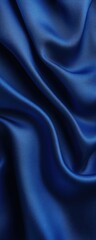 Obraz premium Close-up of luxurious blue silk fabric with flowing drape texture. Perfect for backgrounds, fashion, and design elements.