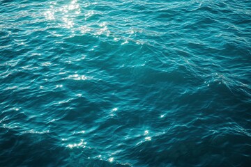 Obraz premium Blue green surface of the ocean in Catalina Island California with gentle ripples on the surface and light refracting , ai