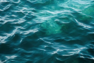 Obraz premium Blue green surface of the ocean in Catalina Island California with gentle ripples on the surface and light refracting , ai