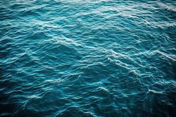 Blue green surface of the ocean in Catalina Island California with gentle ripples on the surface and light refracting , ai