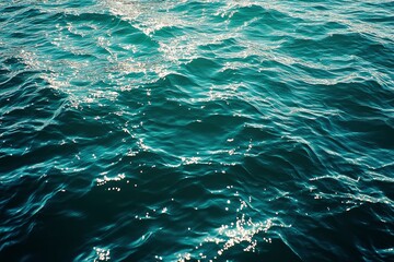 Obraz premium Blue green surface of the ocean in Catalina Island California with gentle ripples on the surface and light refracting , ai