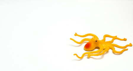 A Yellow Octopus Shaped Children's Toy With Isolated White Background And With Composition Leaving Space On The Left Side