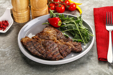Grilled chuck roll steak with arugula