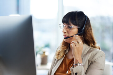 Business woman, computer and call center consultation with customer support and headphones at job....