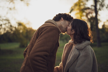 Portrait of happy loving couple in park in sunset.