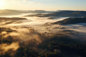 Fototapeta premium Drone view of sun rising over fog shrouded welzheim forest